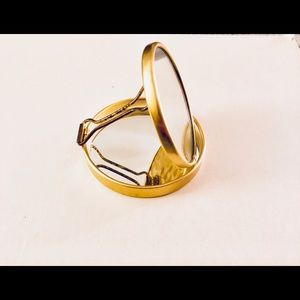 A gold pocket mirror.